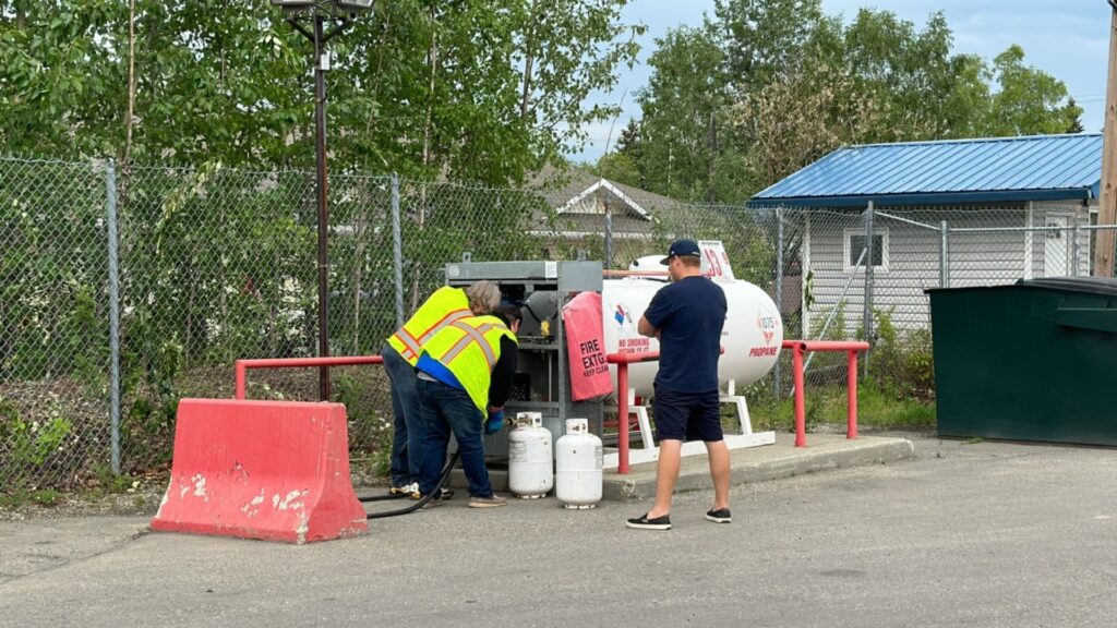 filling a 30lb propane tank at a gas station
