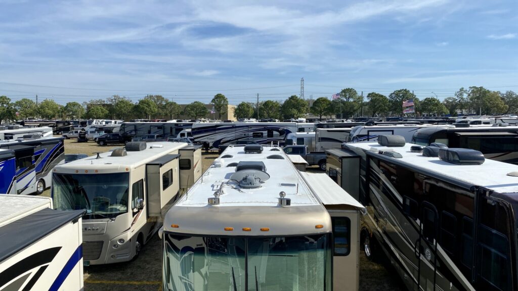 Arieal shot of RVs lined up outside of a pretty day.