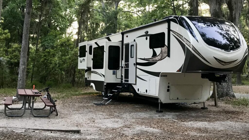 A fifth wheel with a picnic table parked at the campground in Fort McAllister State Park.