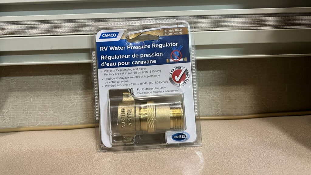 RV water pressure regulator sitting on a counter in the package