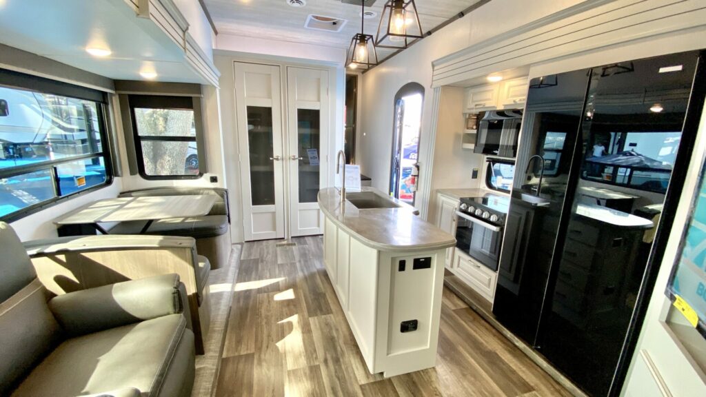 A fifth wheel with an open concept floor plan. Showing the dinette, living room, and kitchen all in one place.