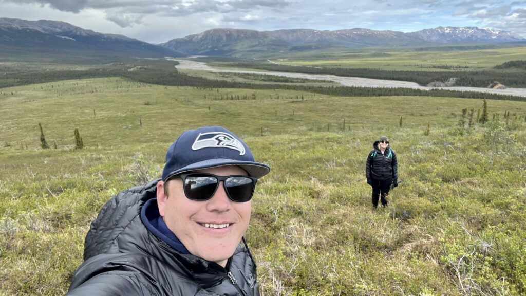Jason take a selfie with Rae in the background at Denali National Park. 