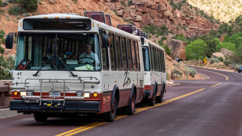 The Zion National Park shuttle bus driving down the main road. 