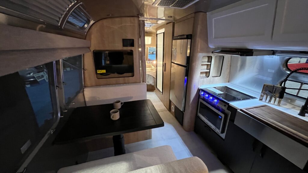 Looking towards the rear of a pottery barn airstream with the kitchen and dinette