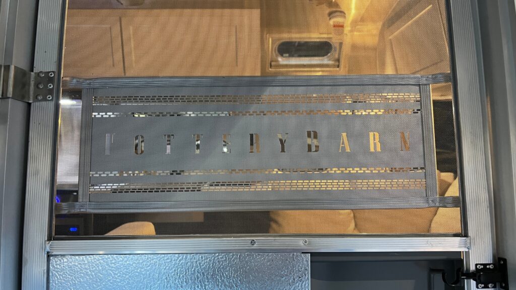 Screen door with a pottery barn logo on a pottery barn airstream
