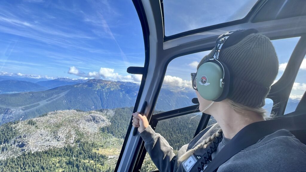 Rae in a helicopter overlooking Whistler, BC.