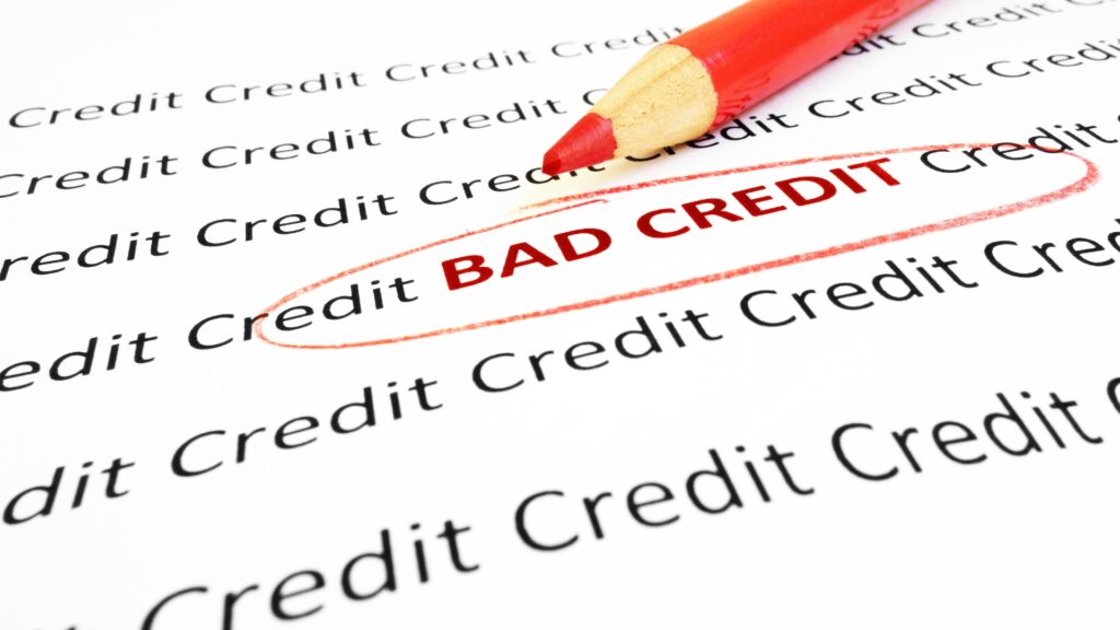 A paper that says bad credit in red with a red circle around it.