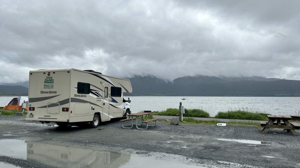 An RV rental parked in site that has an ocean view. They can splurge on good sites now that they know the cheapest way to rent an rv for a month. 