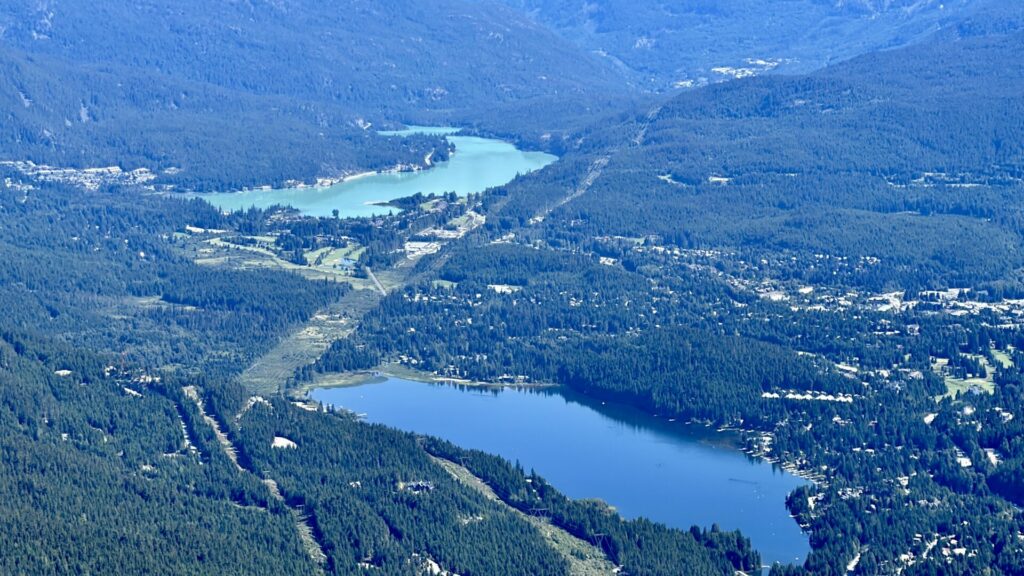 Aerial shot of the two lakes in Whistler Canada and the surrounding town.