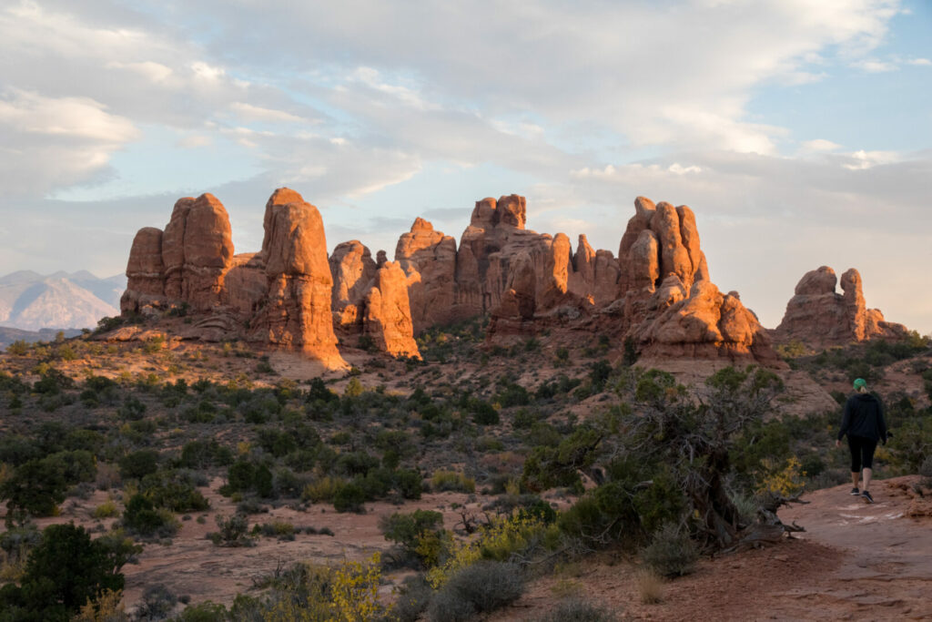 Tall red rocks inside arches national park at sunset.