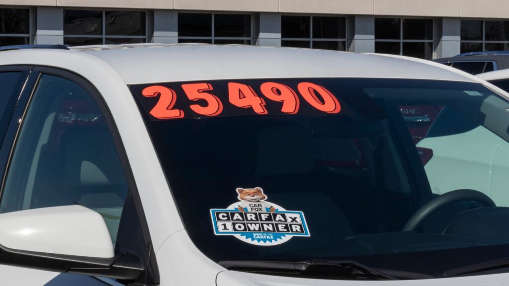 A Carfax sticker on a used car with a sale price of 24,490.