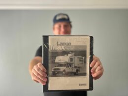 jason of getaway couple holding an old rv manual