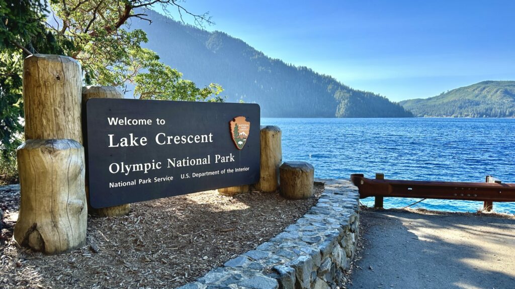 A wooden sign that says welcome to Lake Crescent in Olympic National Park.