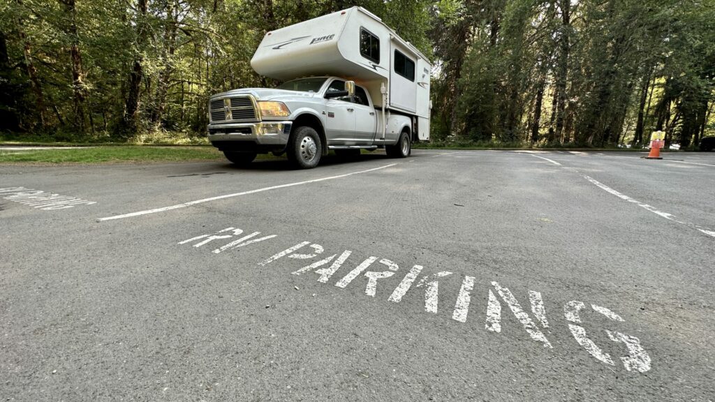 Our truck camper parked in the RV parking section at an olympic national park visitor center.