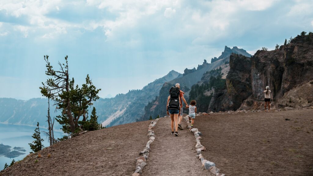 People hiking a trail leading down to Crater Lake.