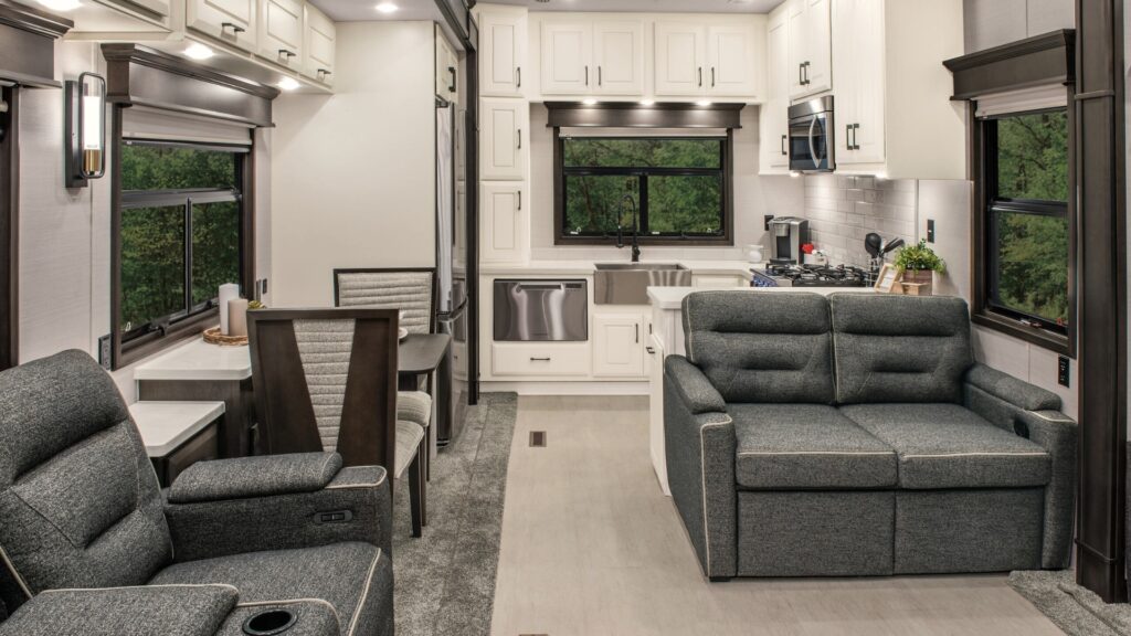 A rear kitchen DRV Mobile Suites floor plan showing the white cupboards and linen couches. 