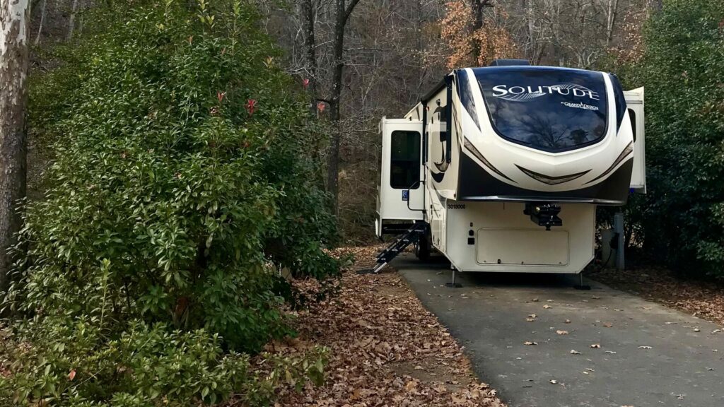 A fifth wheel RV parked in a site at Gulpha Gorge Campground, located at Hot Springs National Park.