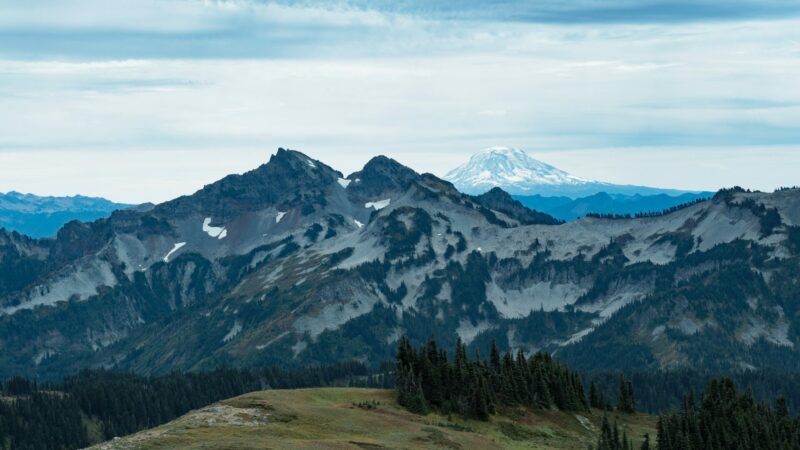 Mount Rainier with a blue cloudy sky in the background.