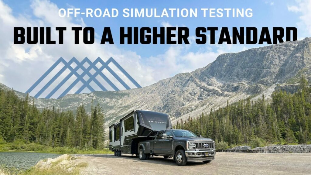 Brinkley Toy Hauler being pulled by a Ford truck in front of a mountain range. A mountain logo with the text "Off-Road SImulation Testing: Built to a Higher Standard" sits above the mountain range in the sky.