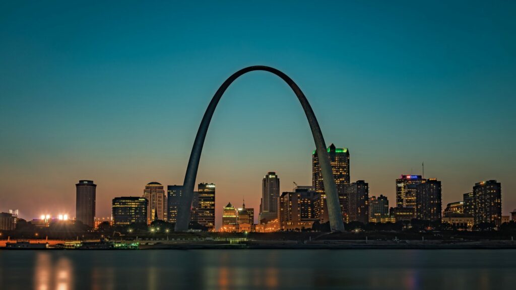 Sunset photo of the St. Louis cityscape with the Gateway Arch.