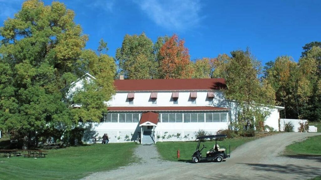 The Kettle Falls Hotel with fall changing trees in the background. 