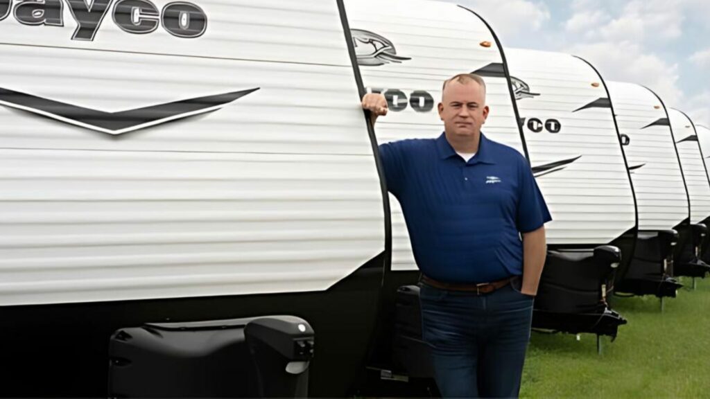 Jayco owner in front of a line of Jayco RV Trailers. 