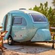 Blue Barefoot retro trailer on the beach.