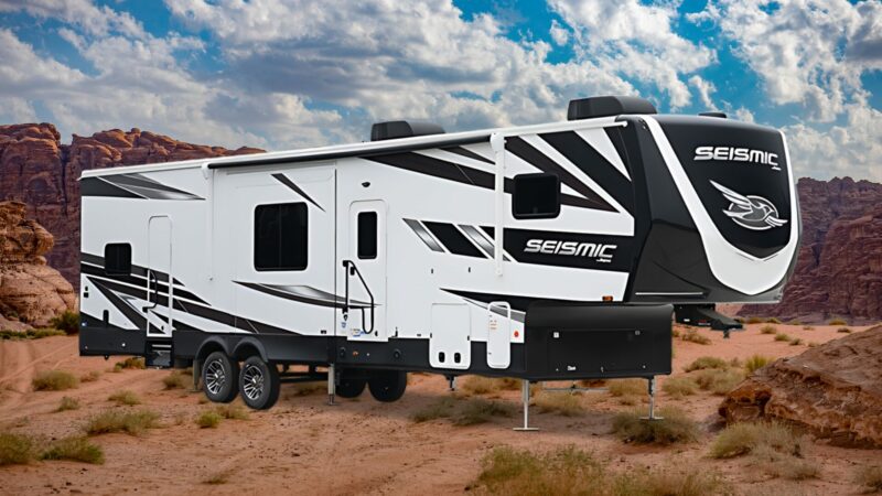 Jayco Seismic Toy Hauler RV with a desert landscape in the back.