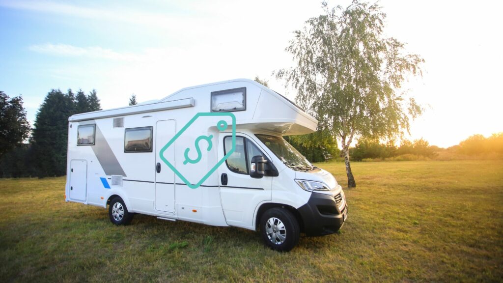 RV in a field with a turquoise price tag graphic overlaid the top of it. 