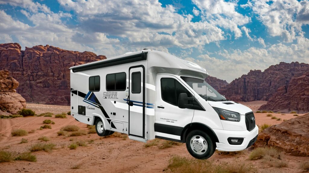 The COachmen Croos Trail 20BH with a redy rocky backdrop and a bright and cloudy blue sky. 