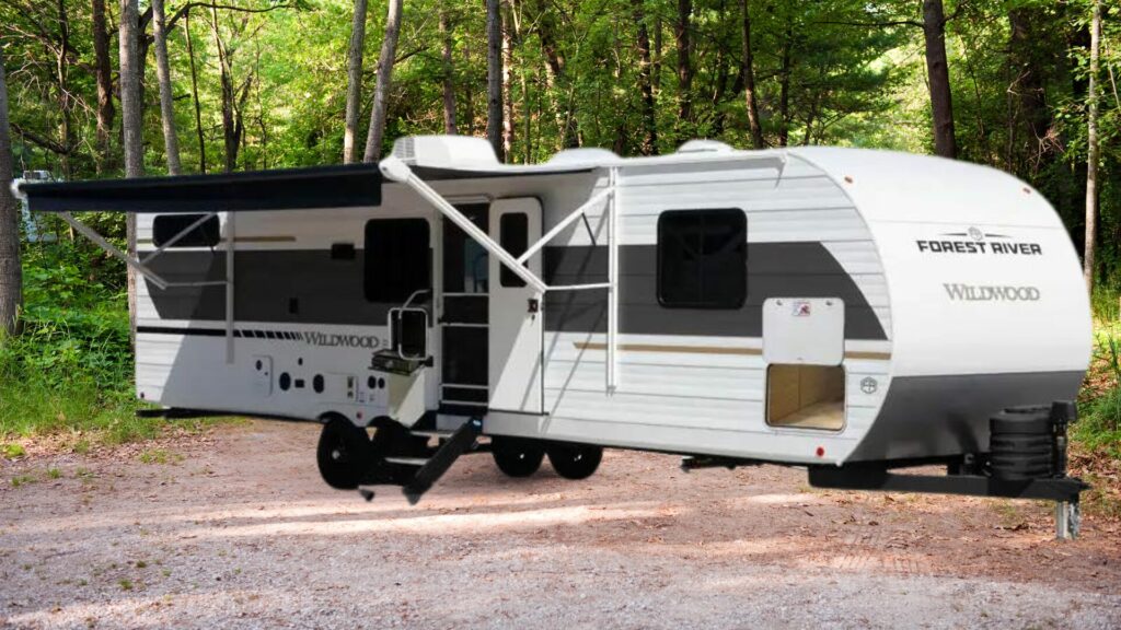 The ForestRiver Wildwood RV travel trailer with a forest background. 