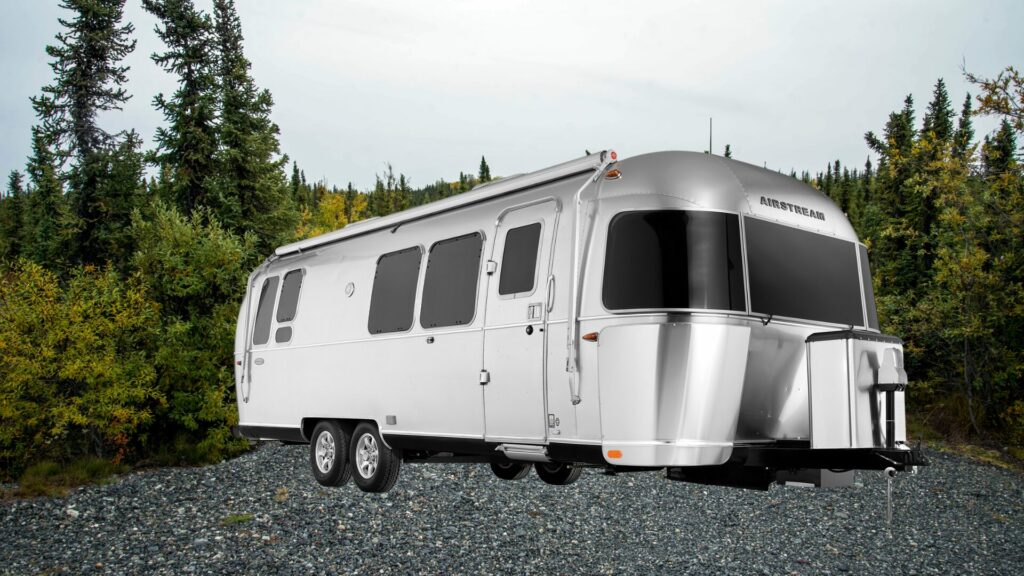 A photo of the Airstream Flying Cloud 28RB RV Travel Trailer with a forest background. 