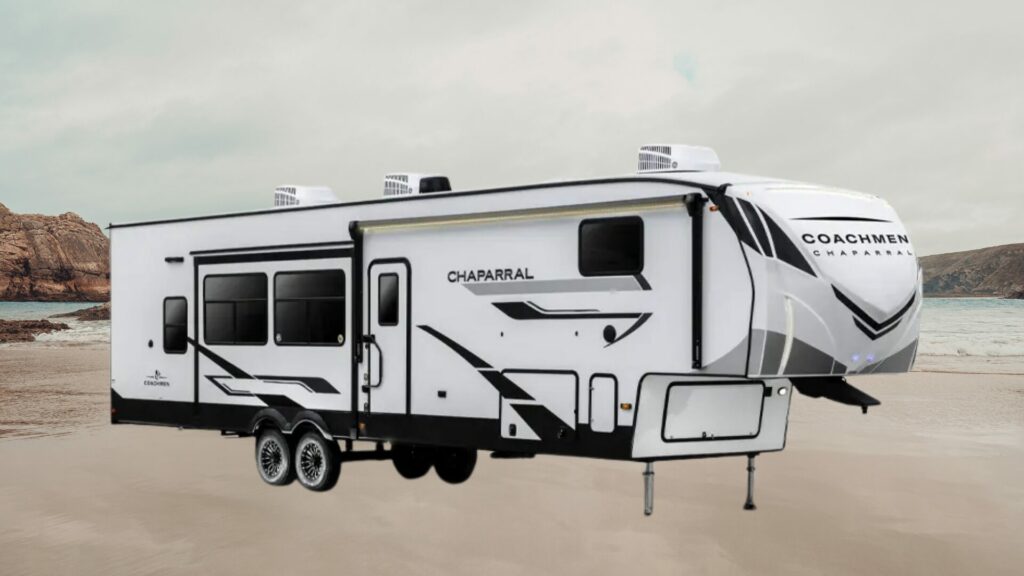 A photo of the Coachmen Chaparral 367BH 5th wheel RV trailer on a beach. 