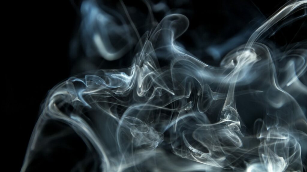 A photo of smoke against a black background. 