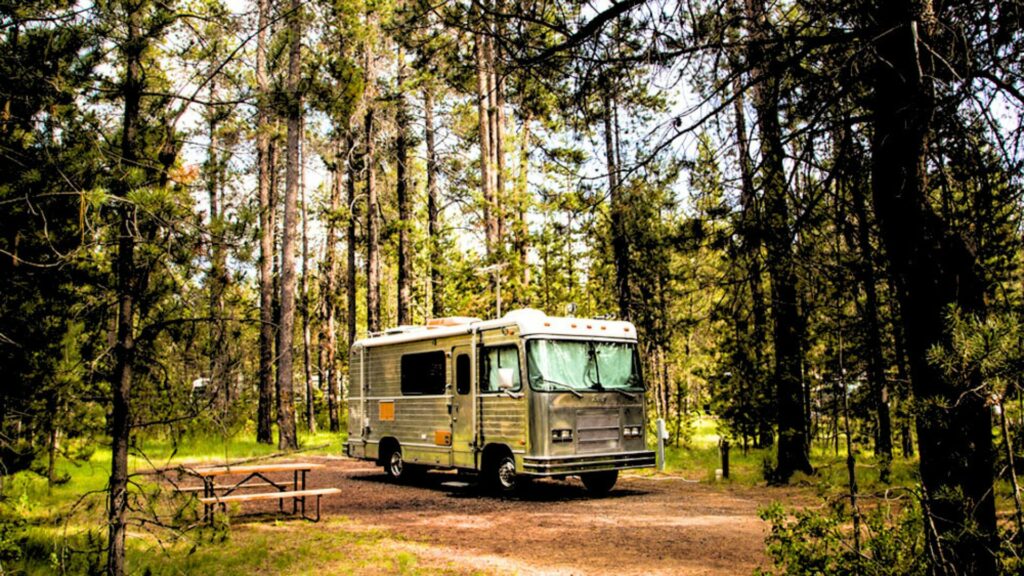 An RV in a spacious lot at the SunRiver Campground by Thousand Trails in Bend, Oregon. 