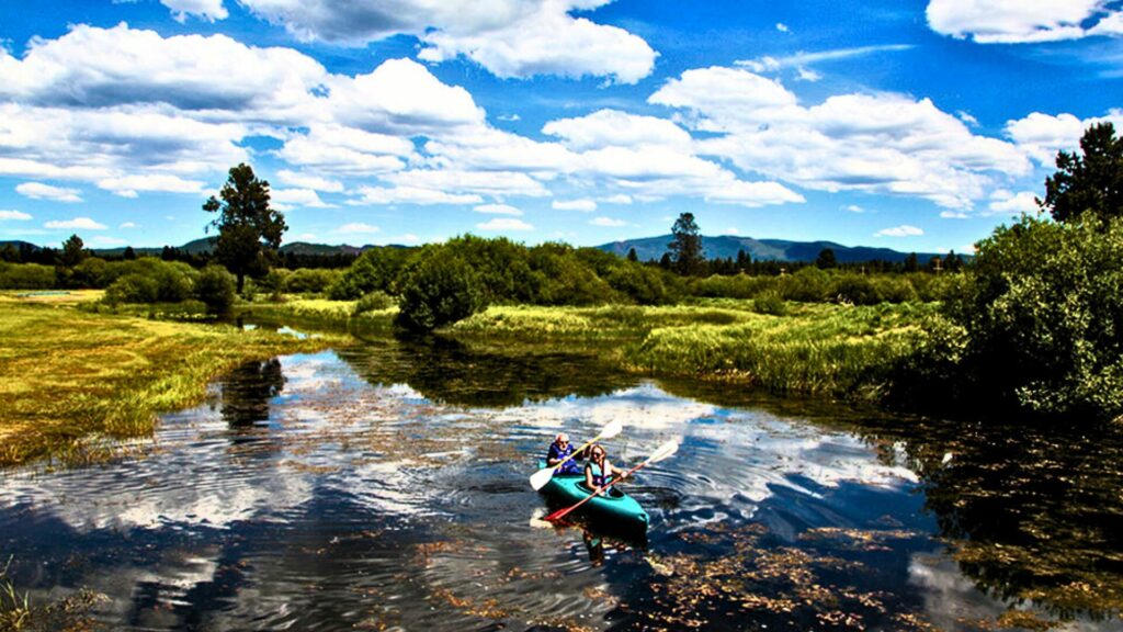 A couple tandem kayaking near the Sunriver Thousand Trails Campground in Bend, Oregon. 