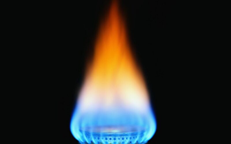 Natural gas aflame with black background.