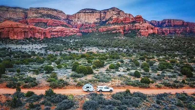 nuCamp Tab 320S being towed through the desert.