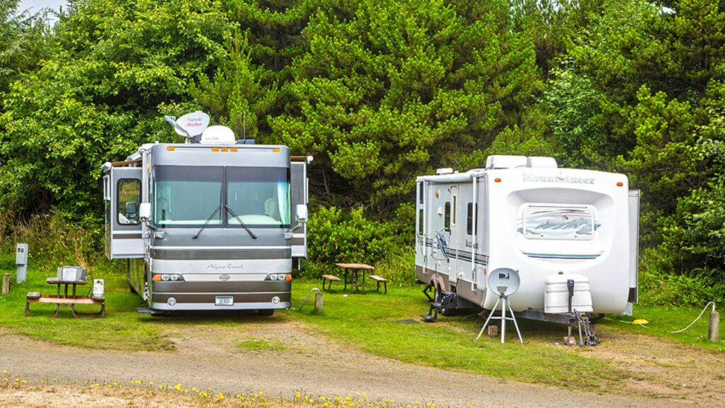 A photo of two RVs side by side displaying the tight sites at Thousand Trails Oceana RV Resort. 