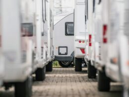 A closeup photo of RV Trailers lined up in a dealership lot.