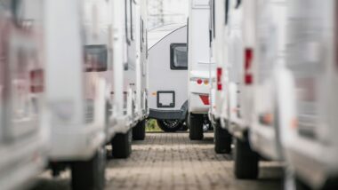 A closeup photo of RV Trailers lined up in a dealership lot.