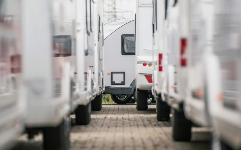 A closeup photo of RV Trailers lined up in a dealership lot.