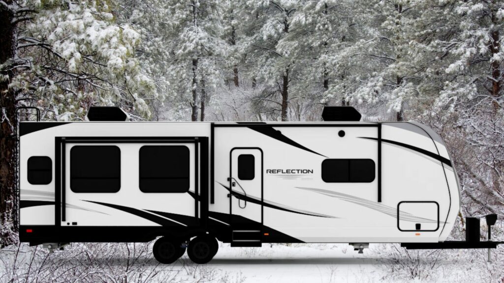 The Grand Design Reflection 312BHTS travel trailer for a family of five exterior with a snowy background. 