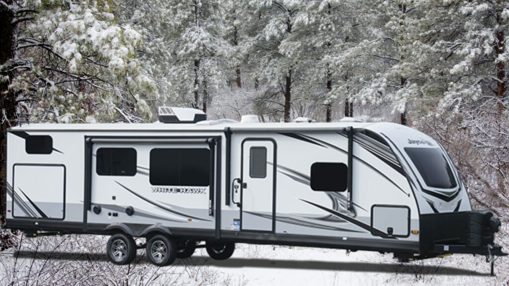 The Jayco White Hawk 32BH Travel Trailer exterior with a snowy background. 