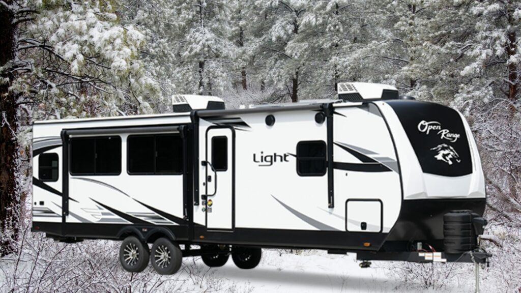 The Open Range 321BHS travel trailer exterior with a snowy background. 