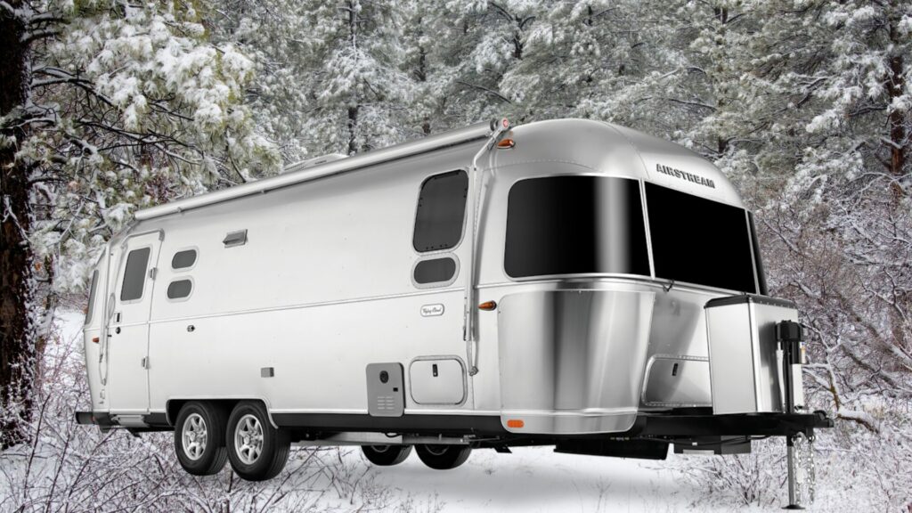 The Airstream Flying Cloud 30FB Bunk travel trailer for a family of five with a snowy background. 