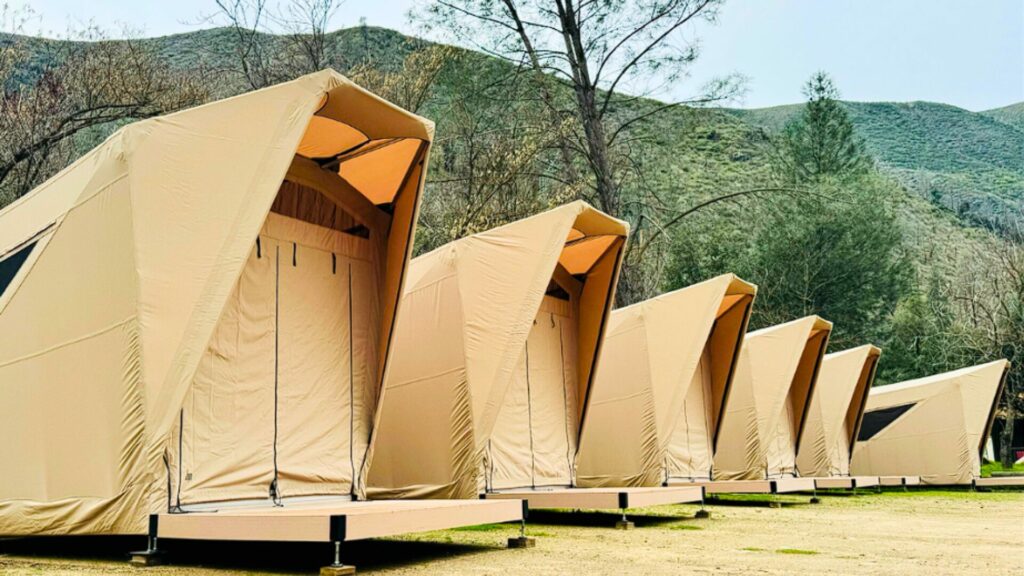 Tan glamping tents are set up at the Indian Flat RV Campground. 