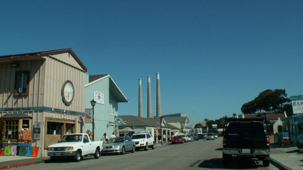 The small town near the Morro Dunes RV Park showcases a few small shops and cars parked along the street. 