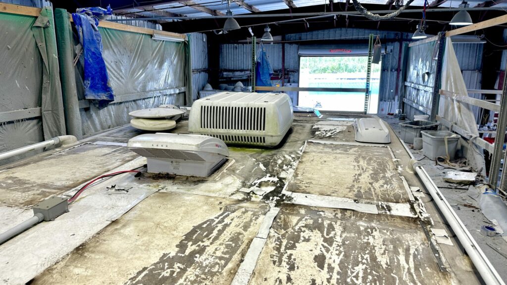 A close up photo of Getaway Couple's RV Roof before the FlexArmor instsallation, looking dirty, ripped up, and damaged. 