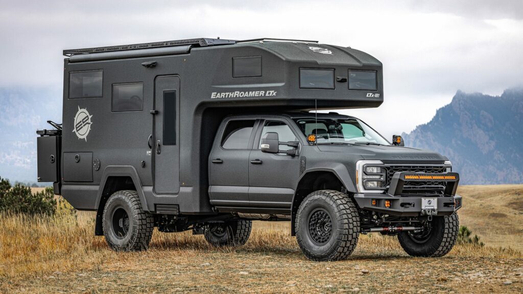 The EarthRoamer LTx camper truck parked in front of a foggy mountain. 